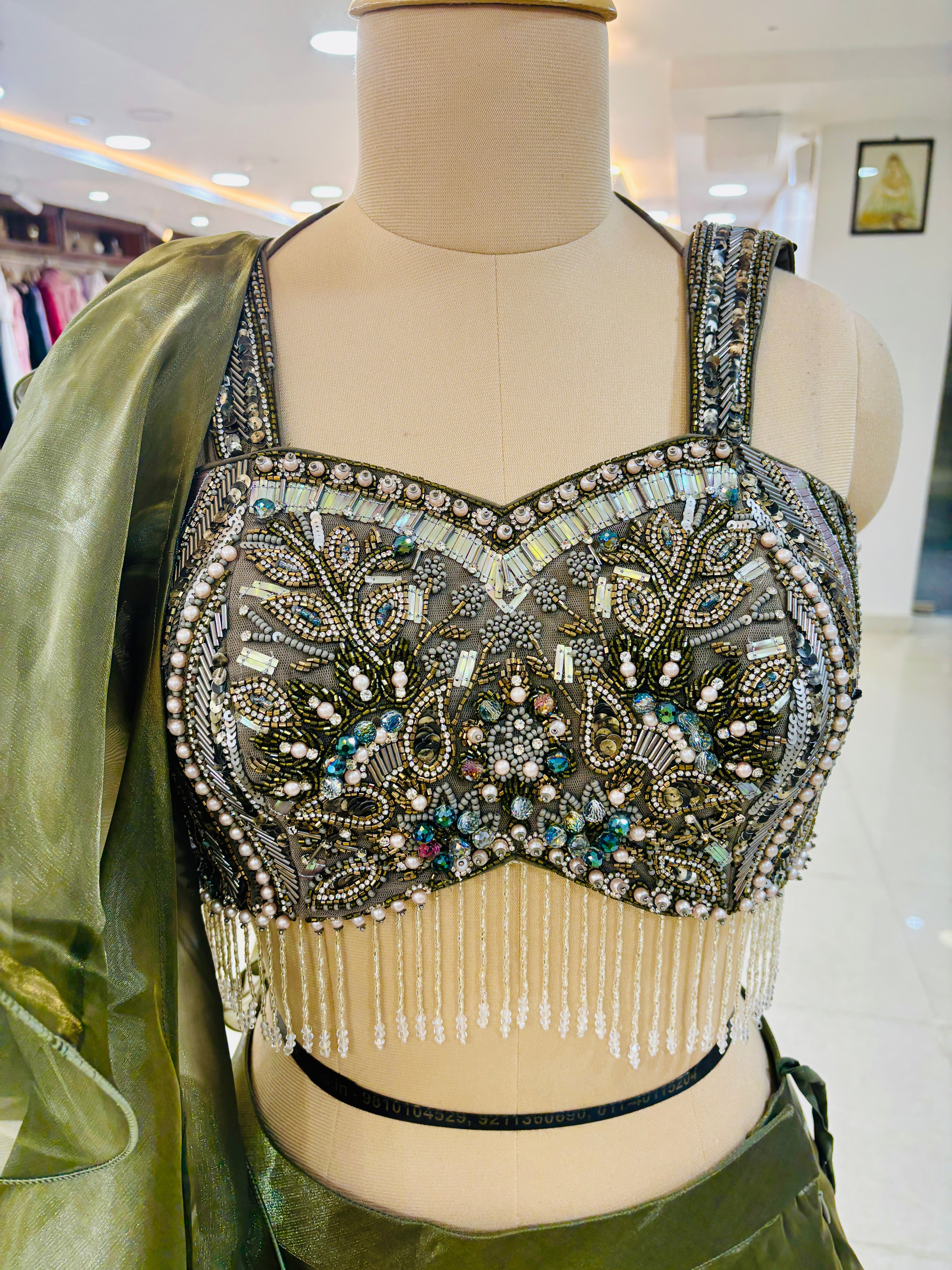 closeup on blouse for Dark Green Layer lehenga Set with ruffle dupatta