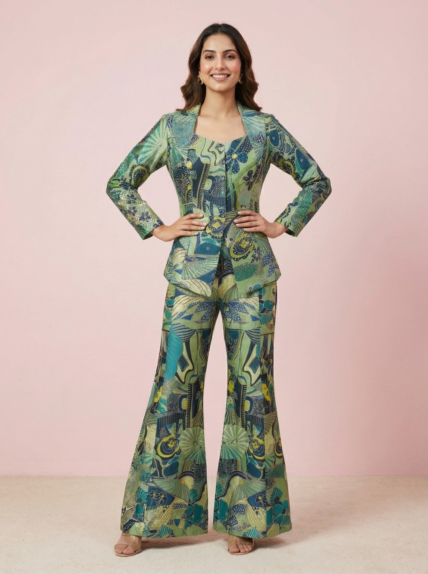 Woman wearing a green and blue patterned suit on a pink background